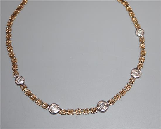 A modern 9ct gold and collet set five stone diamond necklace, 39cm.